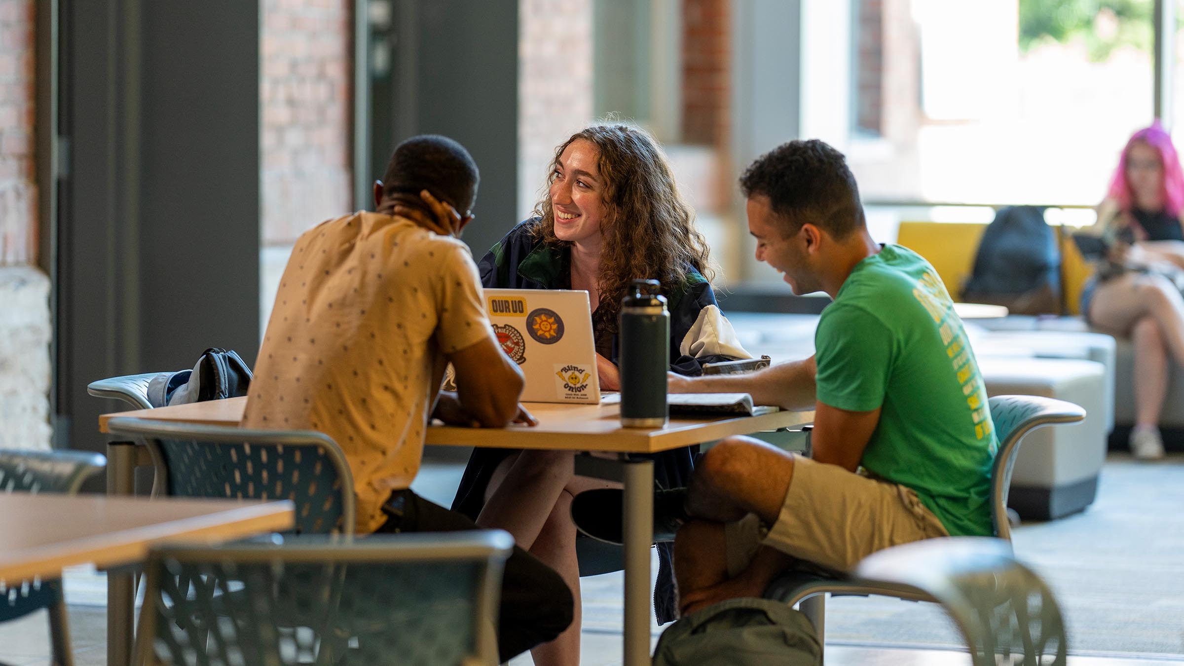 Students working on a group project at a table in the lobby of Allen Hall