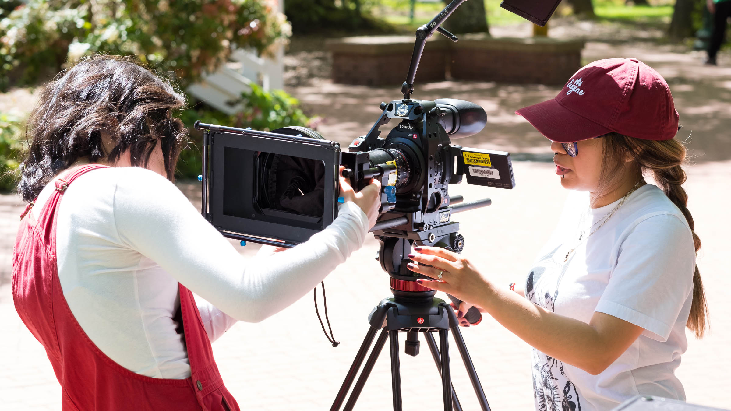Students adjusting camera on set during a documentary film class