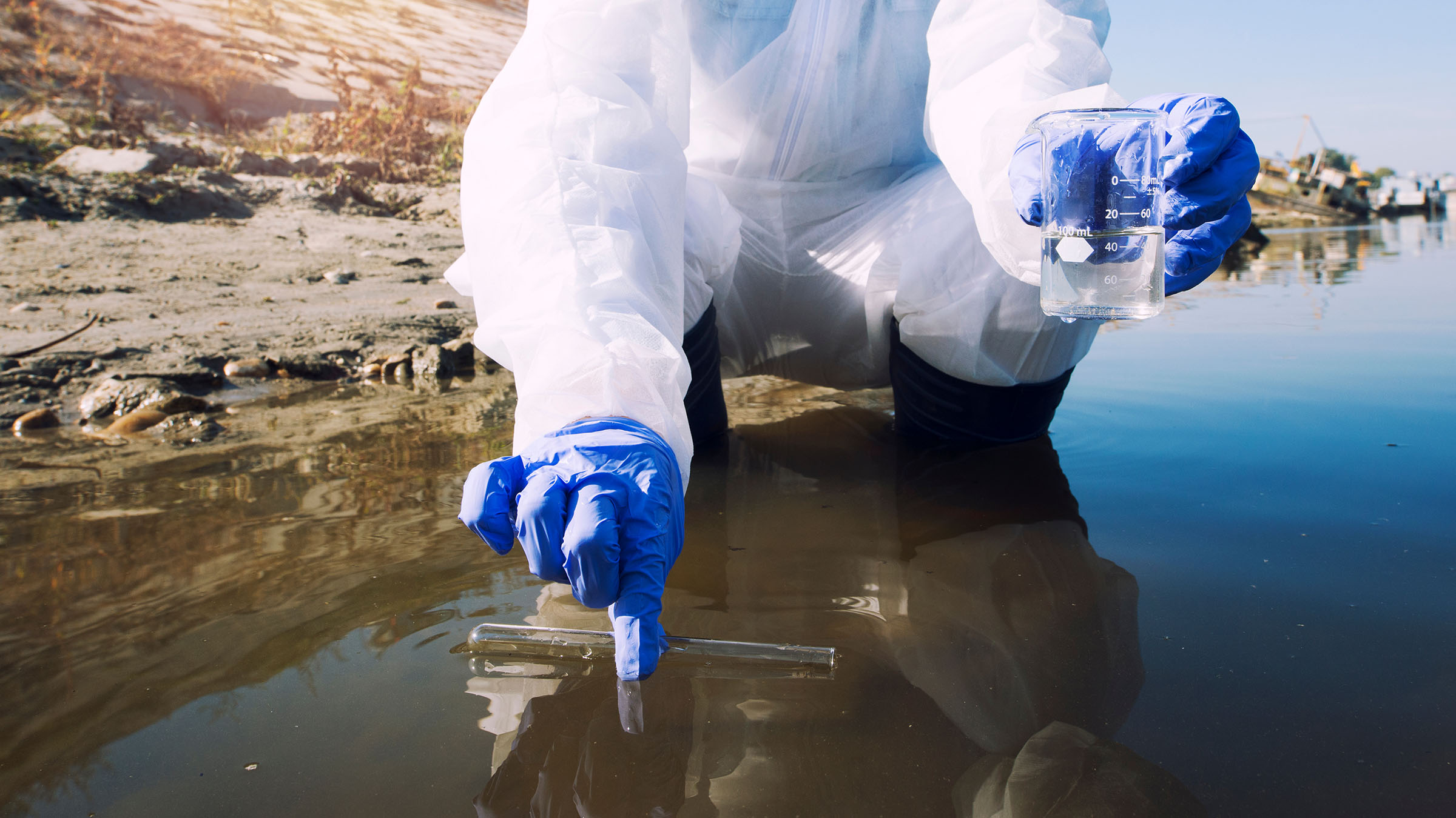Environmental health researcher gathering water samples for analysis