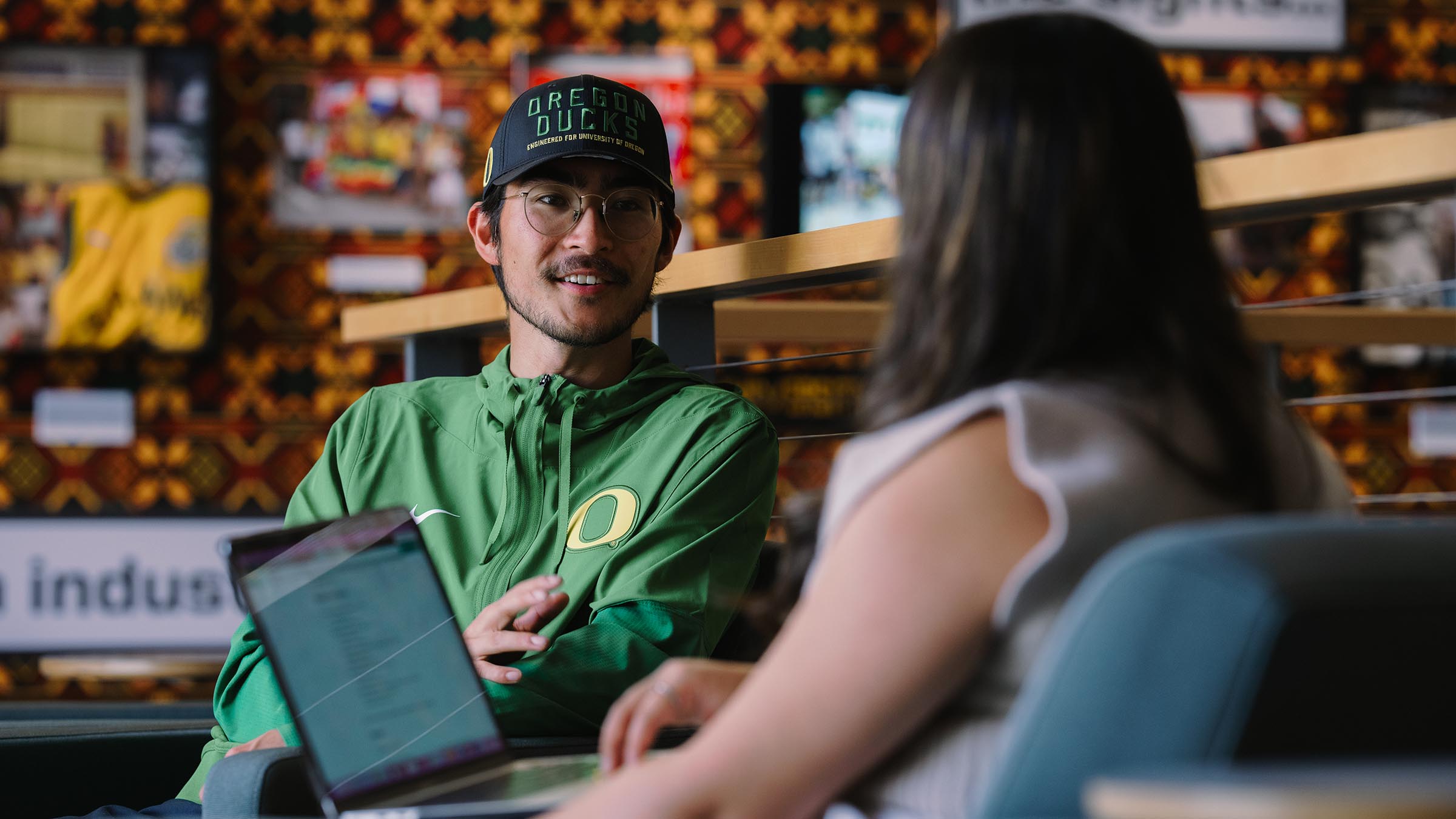 Two students meeting inside Allen Hall, home to the School of Journalism and Communication