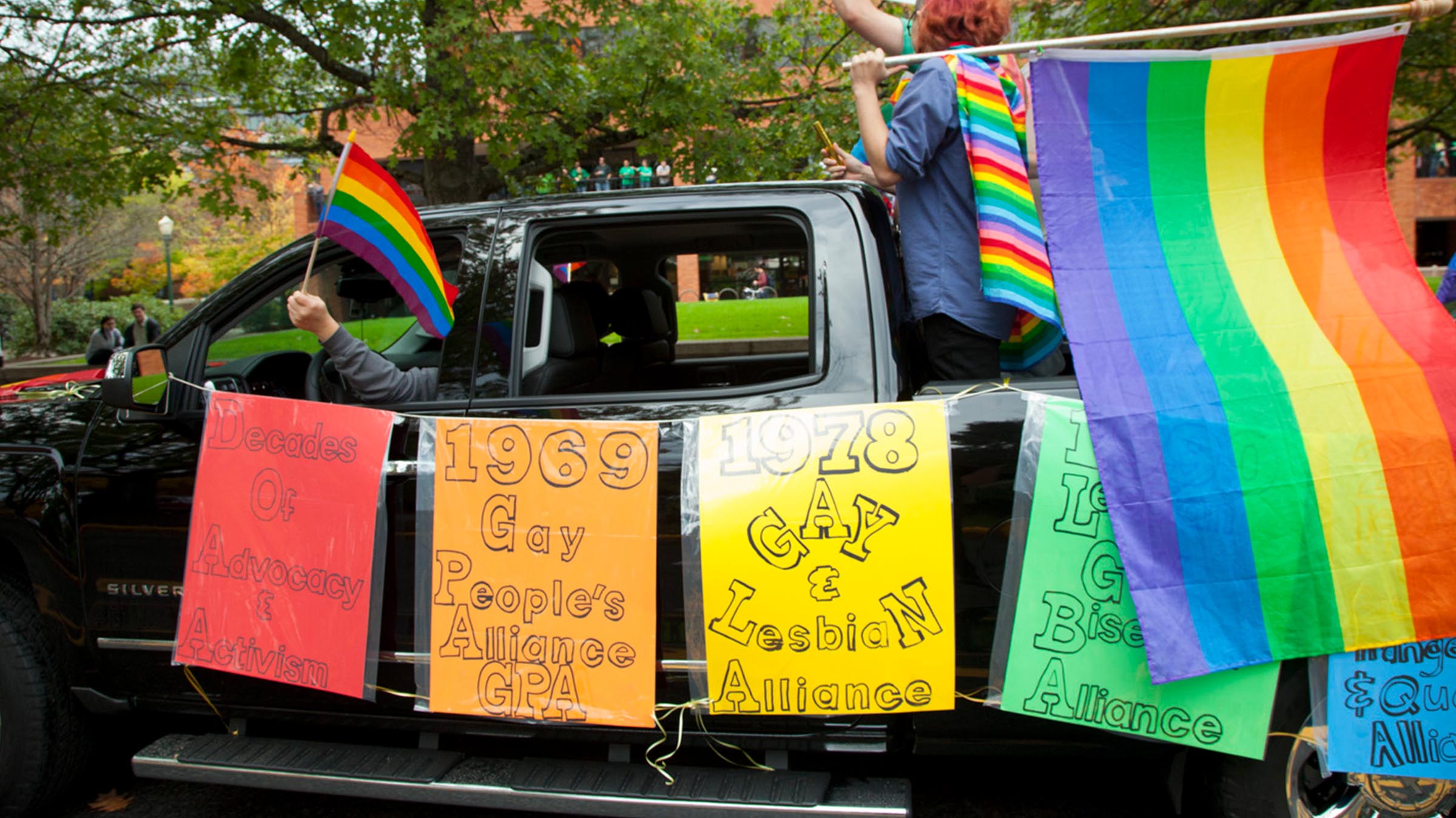 Truck in a campus Pride parade featuring a timeline of LGBTQIA+ advocacy and activism at the University of Oregon