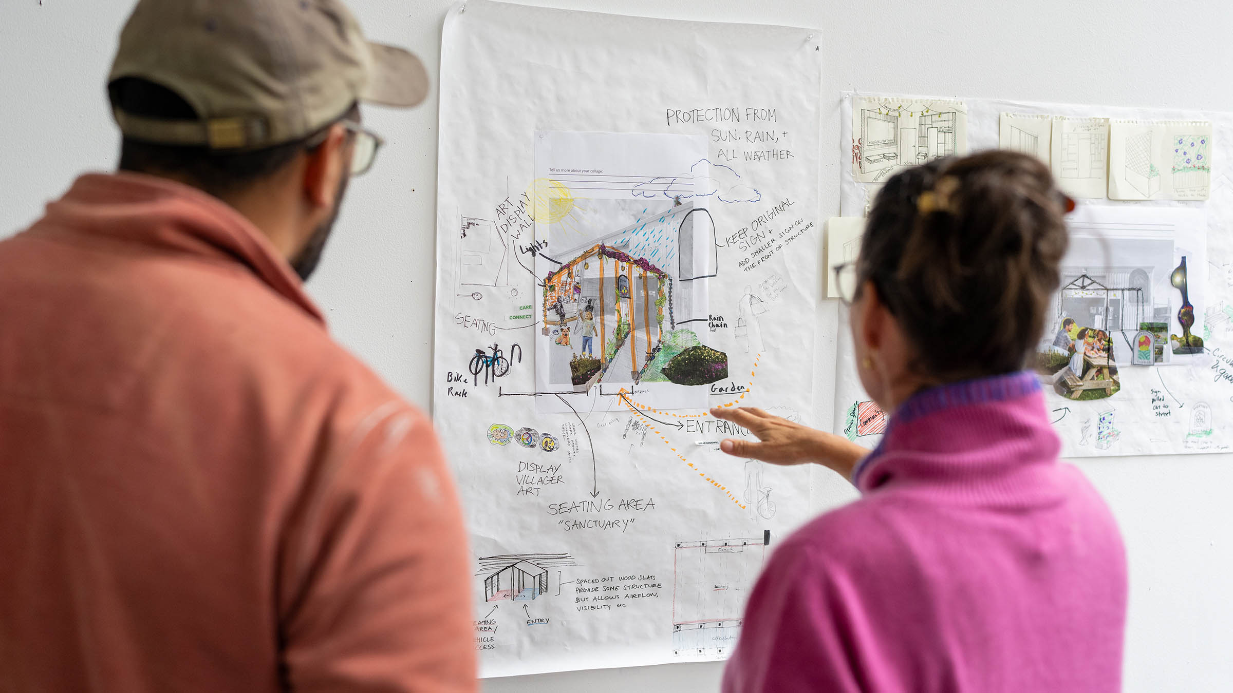 Two people reviewing conceptual environmental plans in an environmental architecture project review