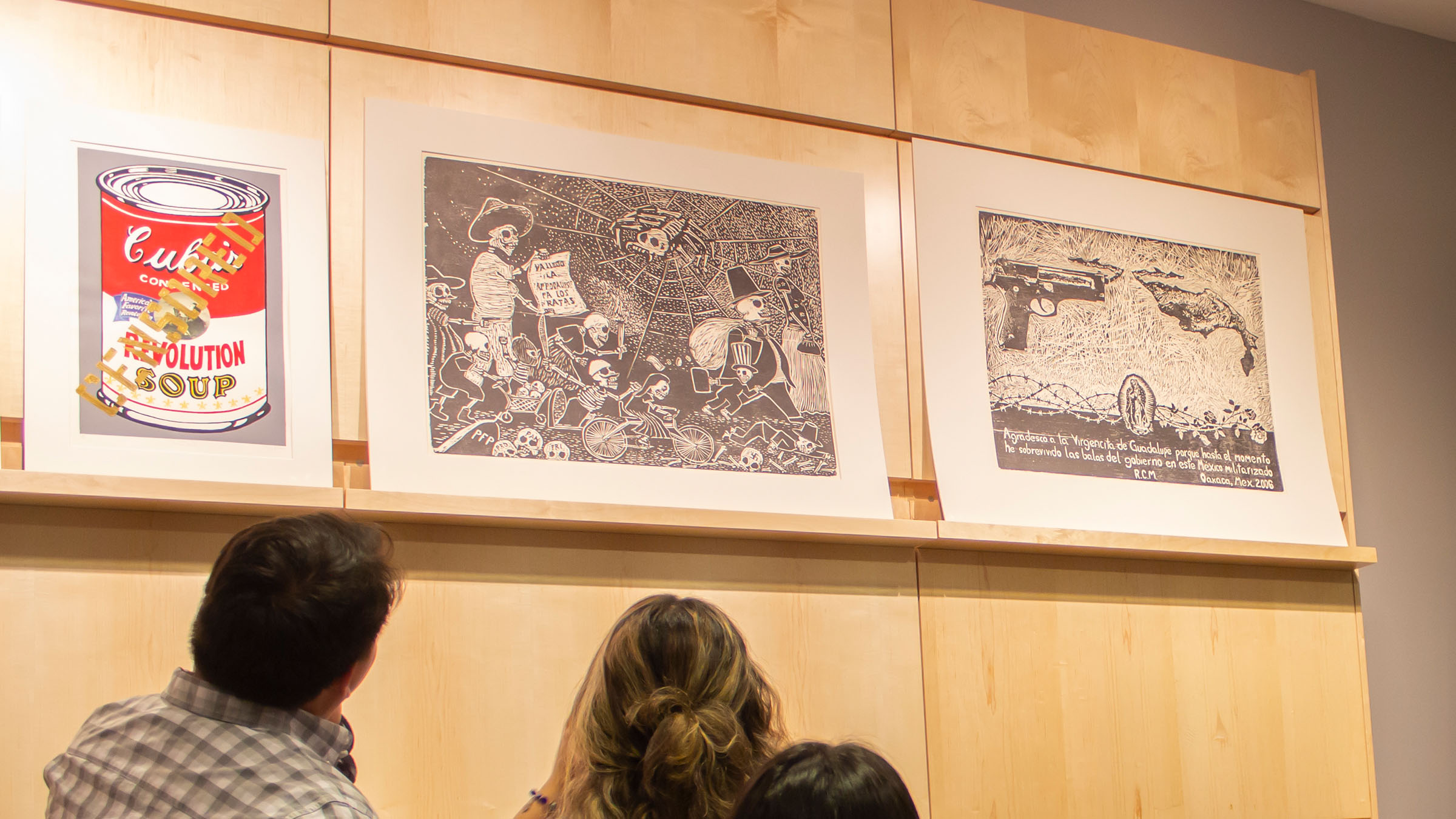 Students at a campus gallery exhibition featuring Latin American and Latinx-themed art
