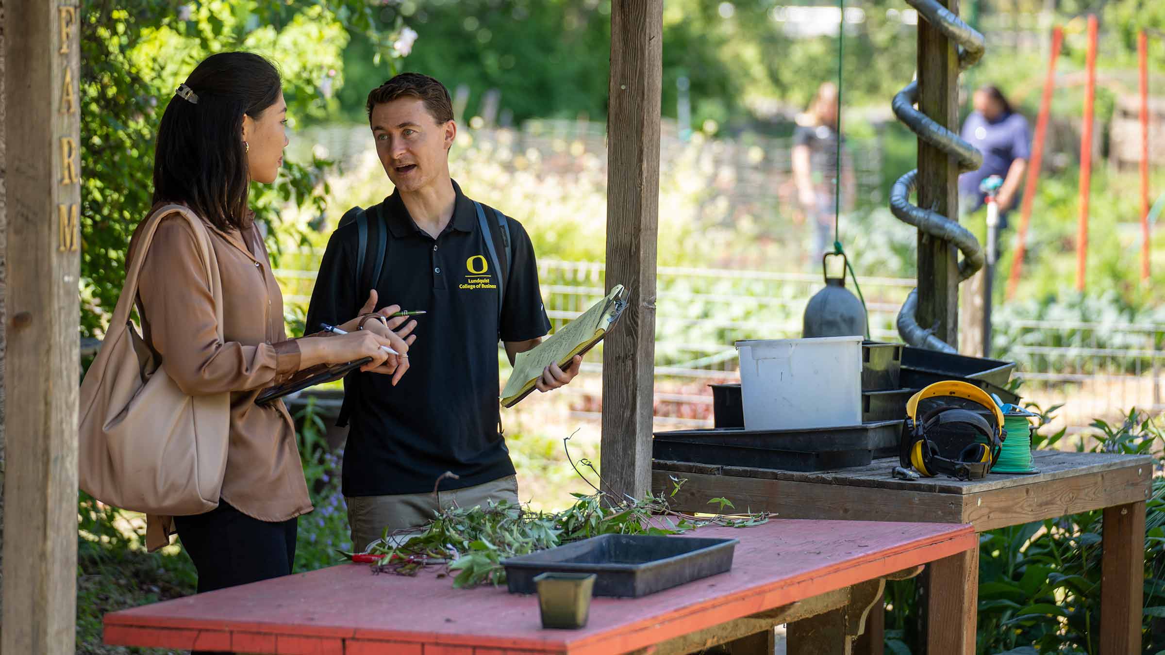 Students evaluating operations at an urban farm as part of a sustainable business project
