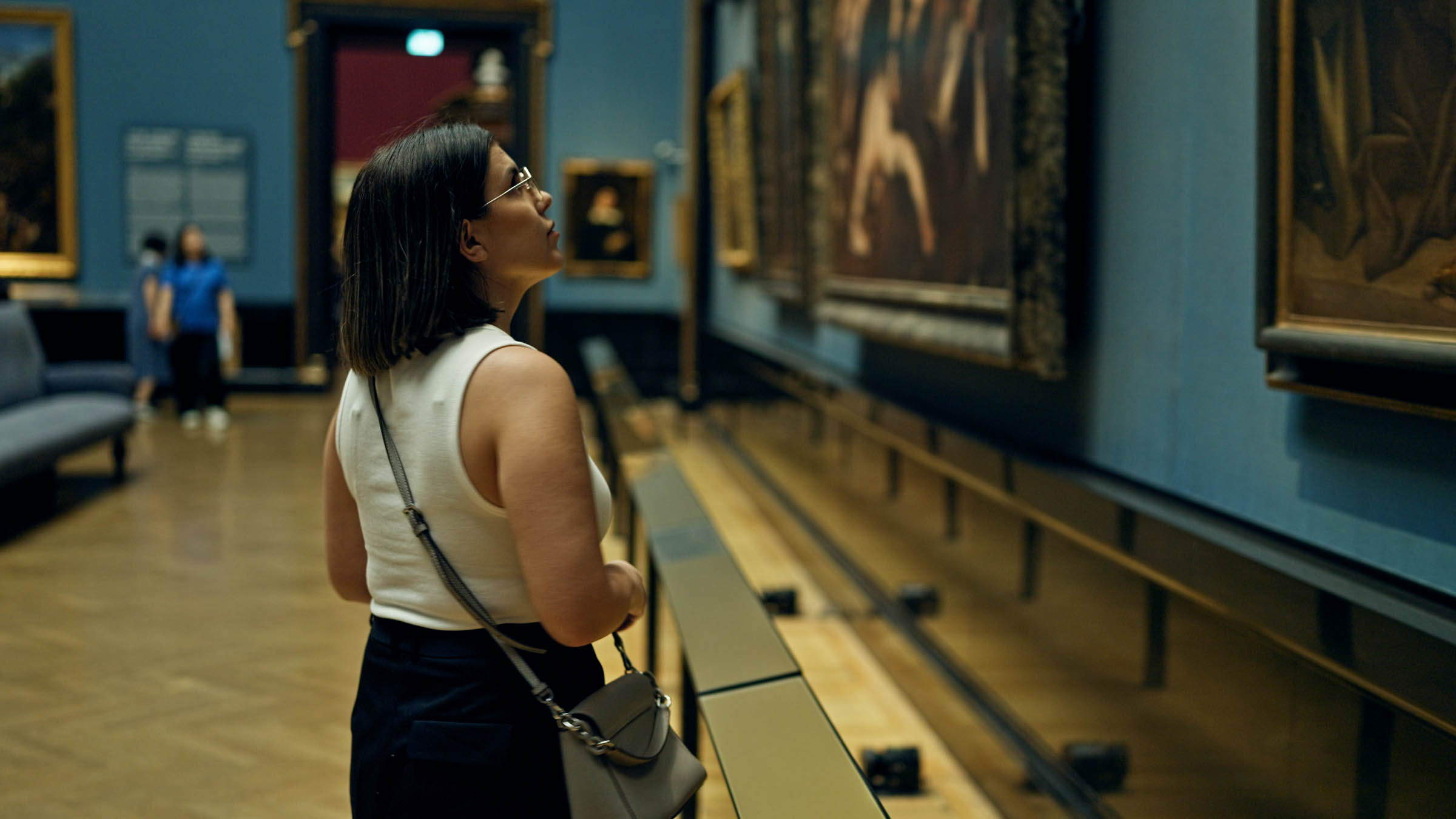 Student studying paintings on display at a museum in Vienna, Austria