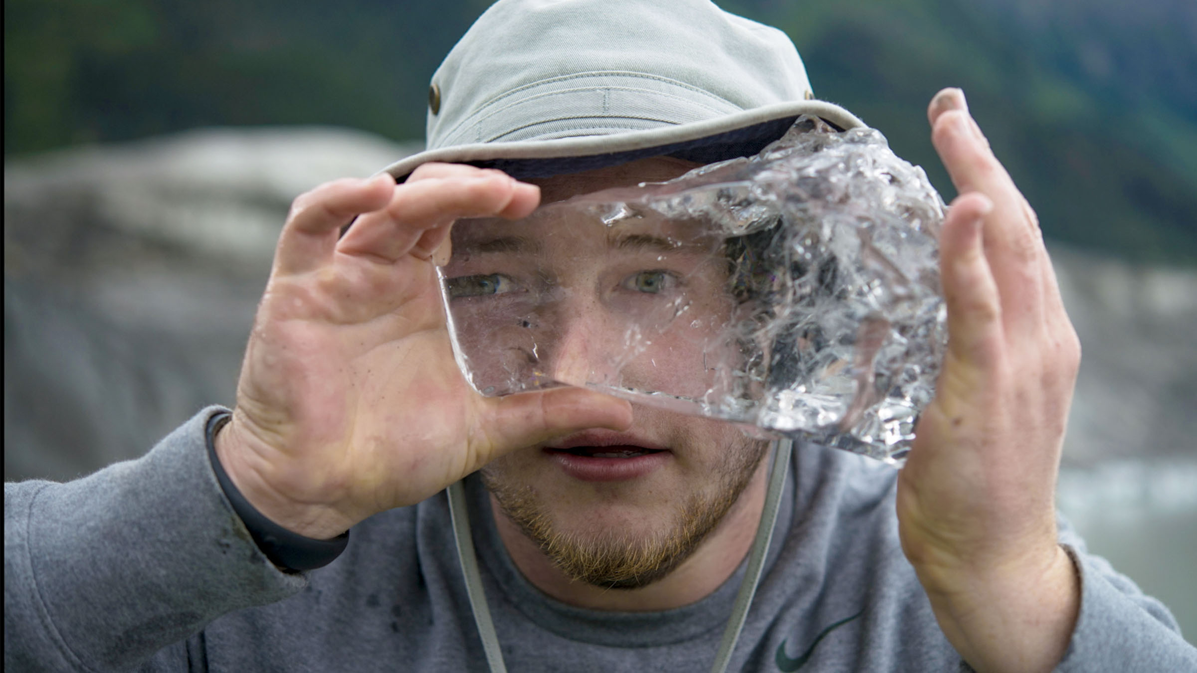 Student examines a large piece of glacier ice during field research