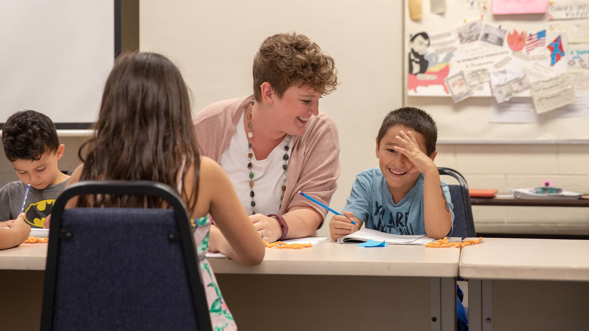 Future teacher working with elementary-age students during a classroom learning activity