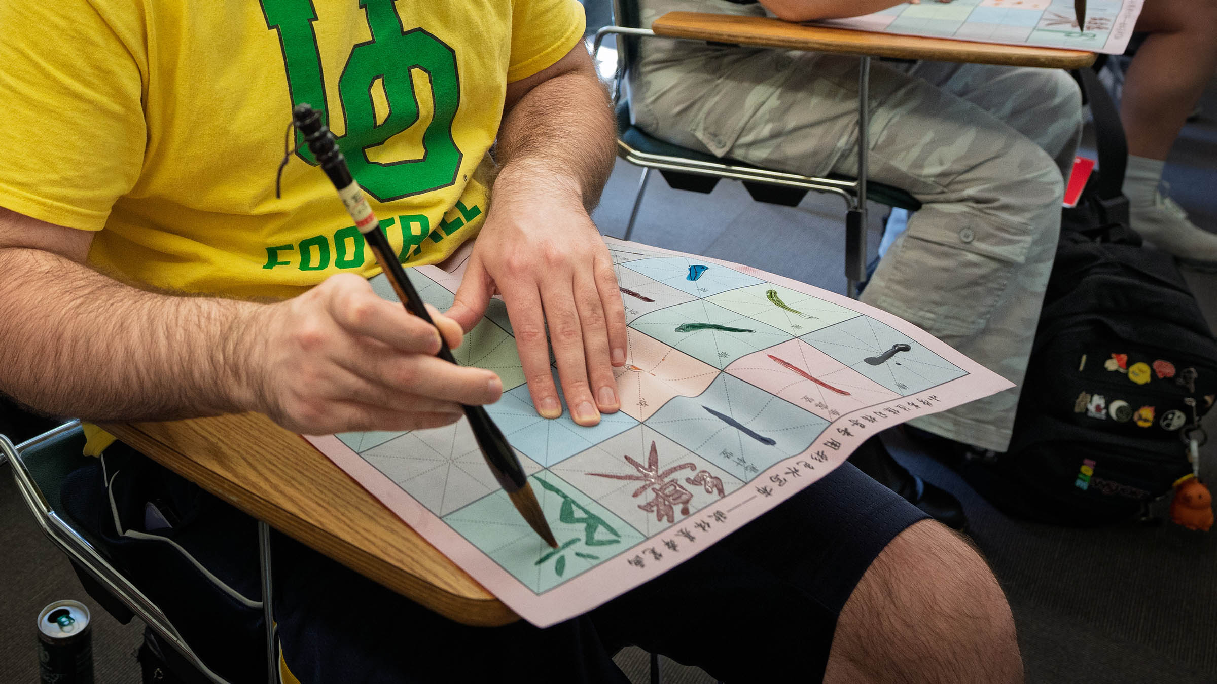 Student learning to write Chinese characters with a traditional brush