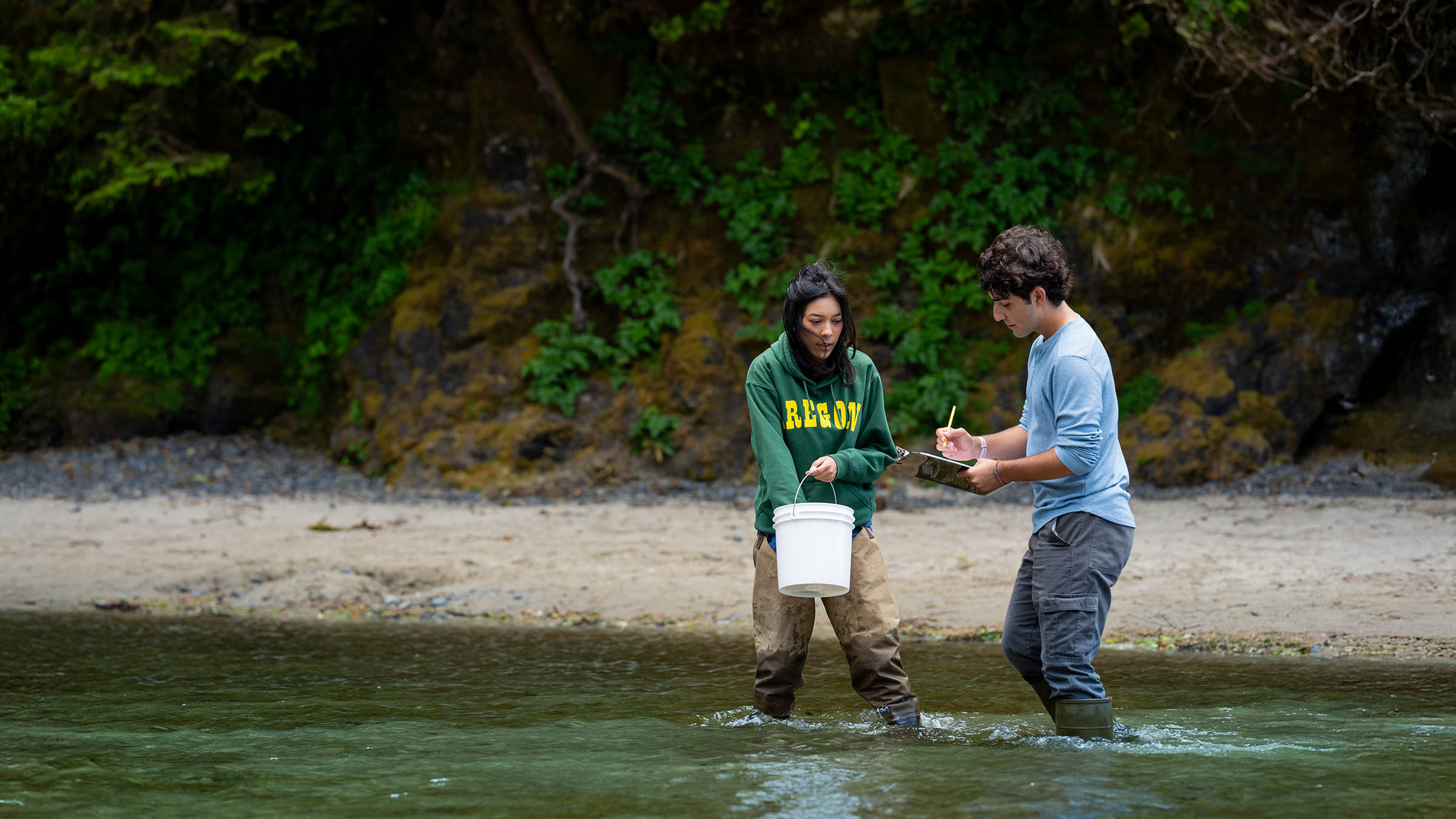 Students collecting samples and recording observations during marine biology fieldwork on the Oregon coast