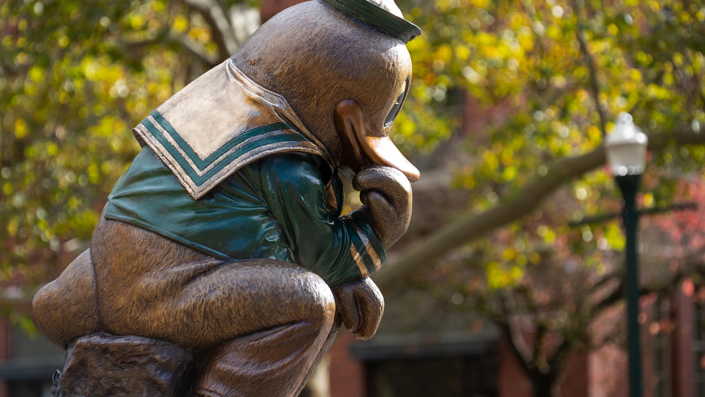 Photo of the "Thinker Duck" statue outside Lillis Business Complex