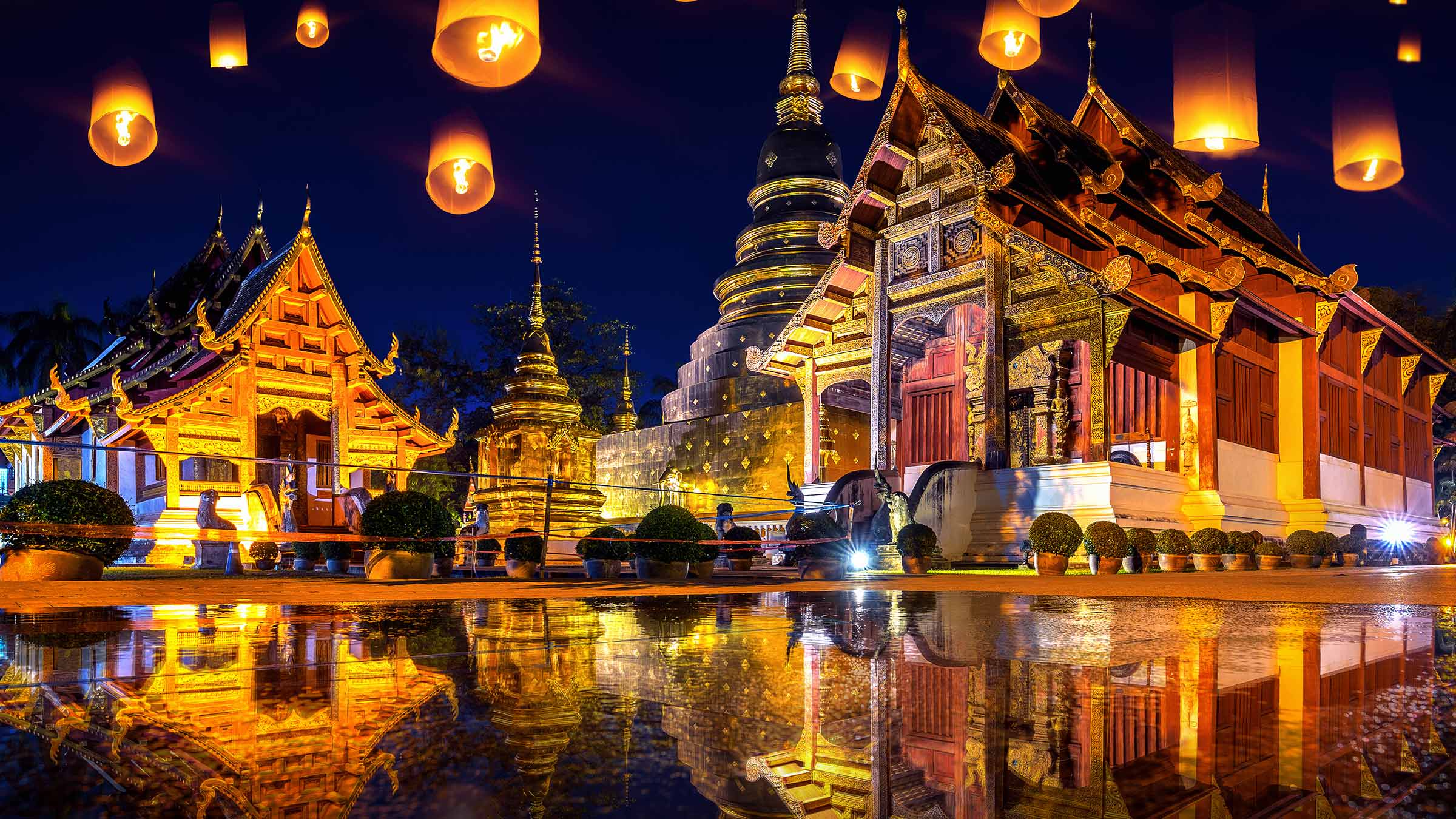 Lanterns rising into the night air at Wat Phra Singh temple in Chiang mai, Thailand