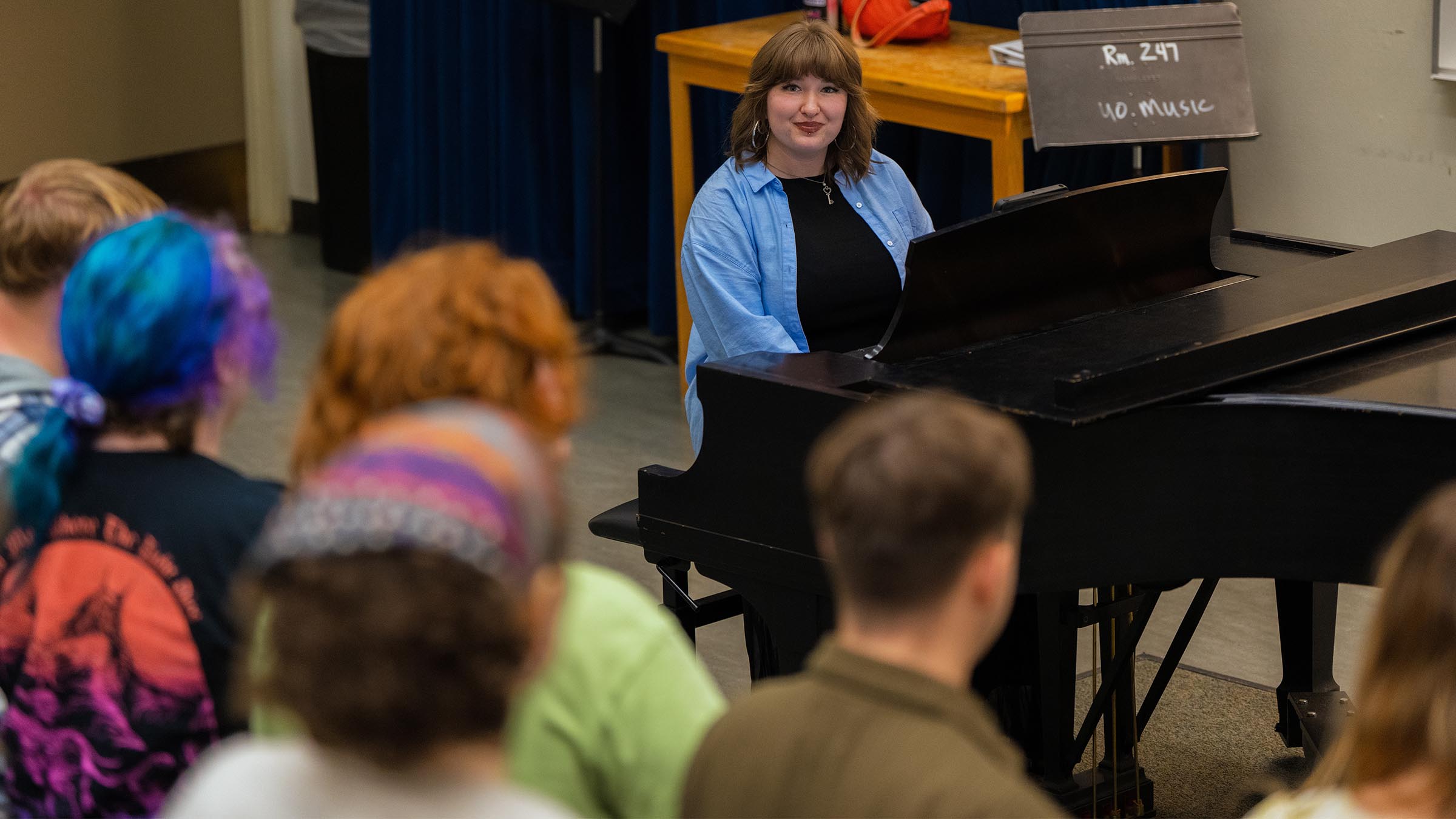 Music education student leading a classroom lesson from the piano