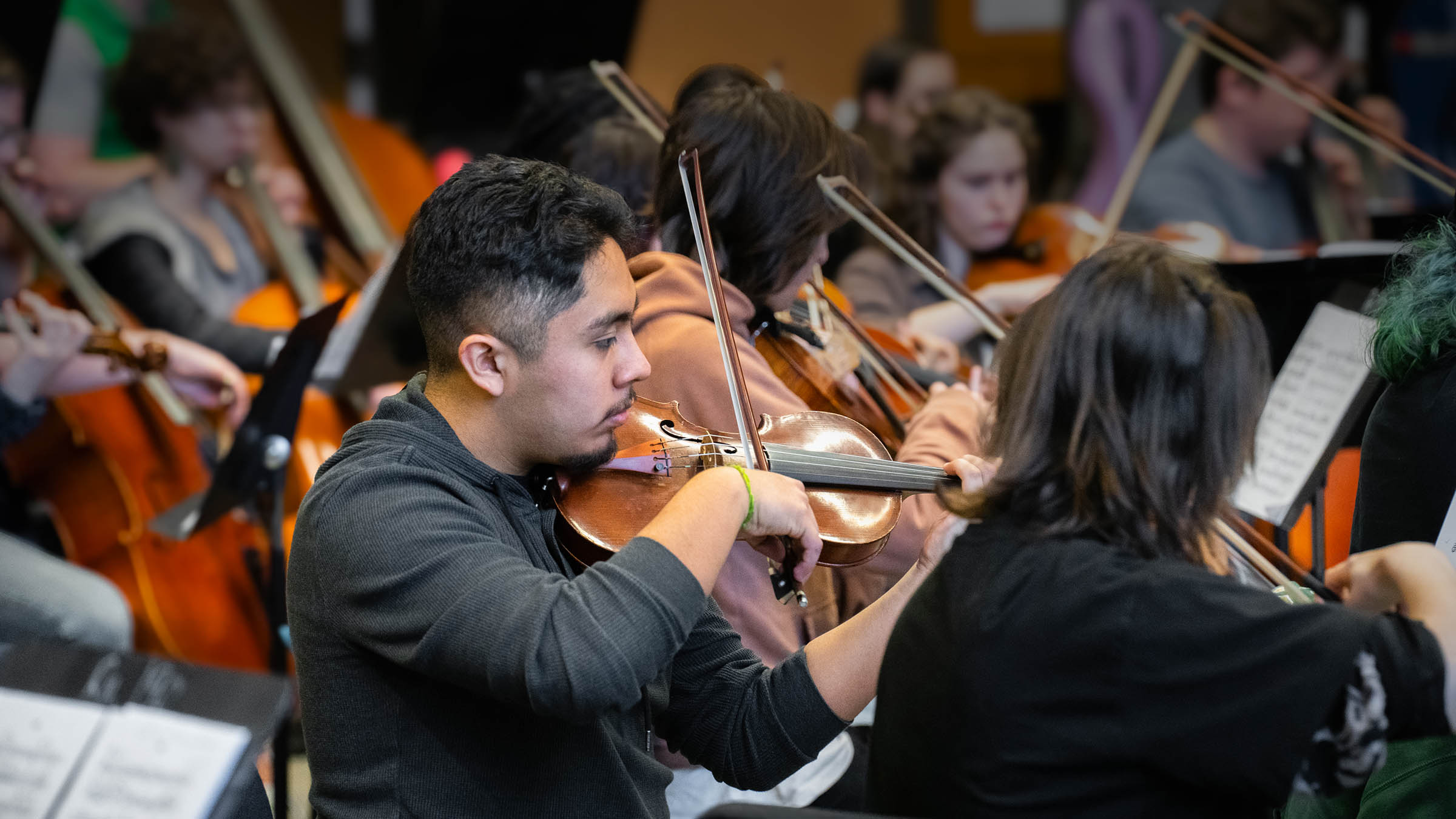Music students rehearsing as part of a university orchestra ensemble